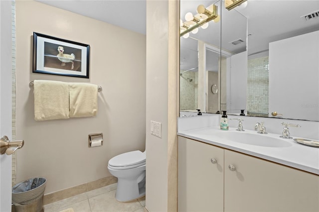 bathroom featuring tile patterned flooring, vanity, a shower, and toilet