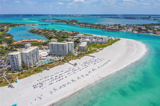 drone / aerial view with a water view and a beach view