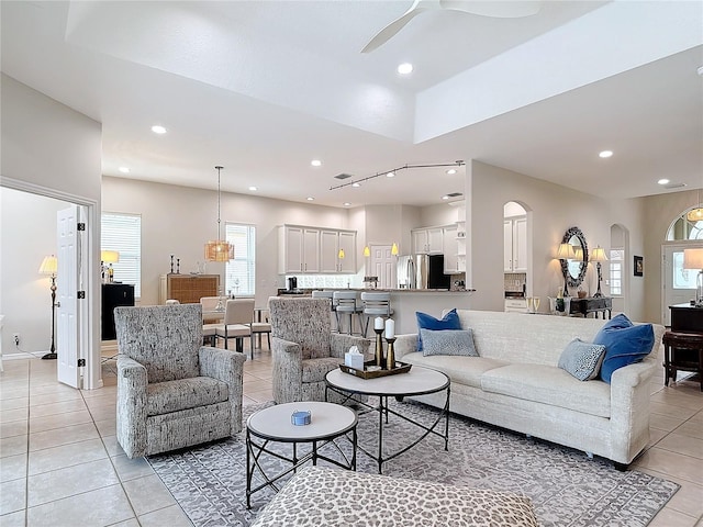 living room with light tile patterned floors and ceiling fan