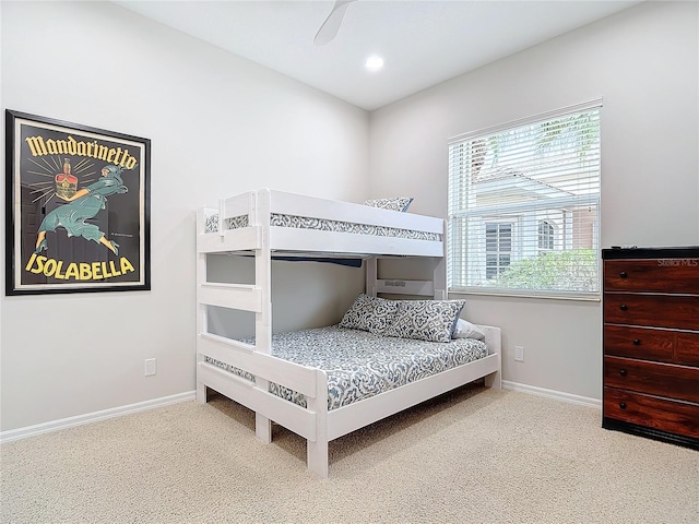 bedroom with multiple windows, ceiling fan, and carpet