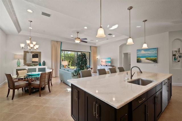 kitchen featuring dishwasher, sink, pendant lighting, and a tray ceiling