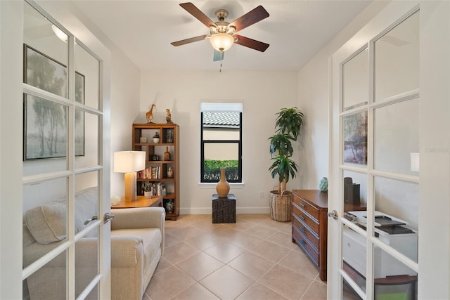 sitting room featuring french doors, ceiling fan, and light tile patterned flooring