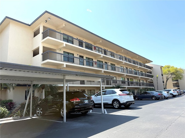 view of building exterior featuring uncovered parking