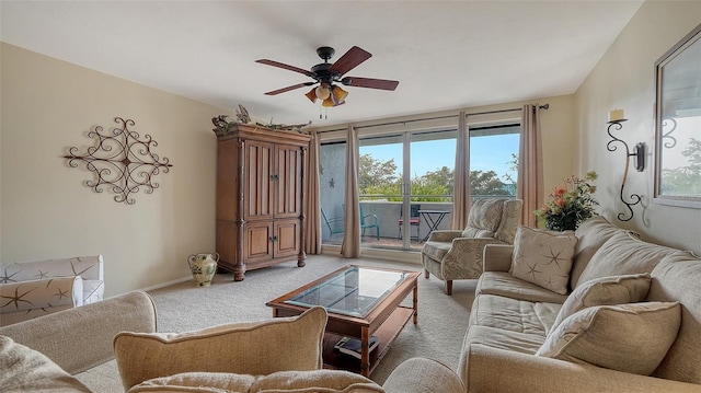 carpeted living room with ceiling fan