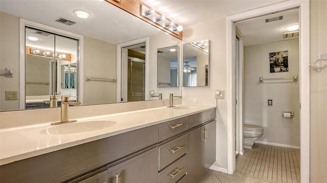 bathroom with walk in shower, tile patterned floors, toilet, vanity, and ceiling fan