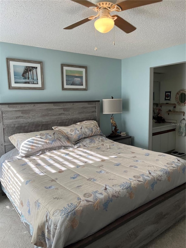 bedroom with a textured ceiling, ceiling fan, and carpet