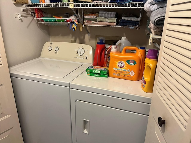 clothes washing area with washing machine and dryer