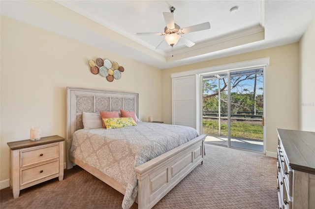 bedroom with ceiling fan, access to exterior, a raised ceiling, and dark carpet