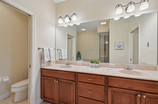 bathroom featuring vanity, tile patterned floors, and toilet