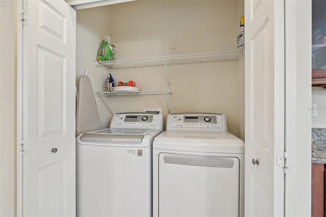 laundry area with washing machine and clothes dryer