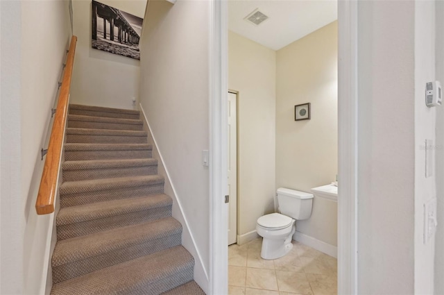 staircase featuring tile patterned flooring