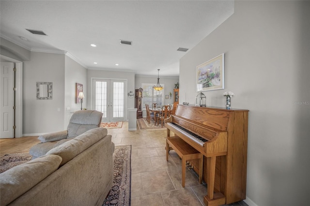 tiled living room featuring ornamental molding and french doors