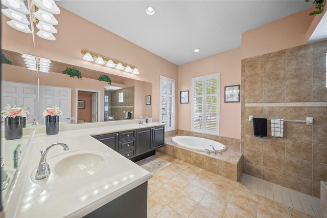 bathroom featuring tile patterned flooring, vanity, and separate shower and tub