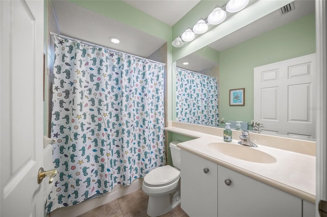 bathroom with vanity, walk in shower, tile patterned floors, and toilet