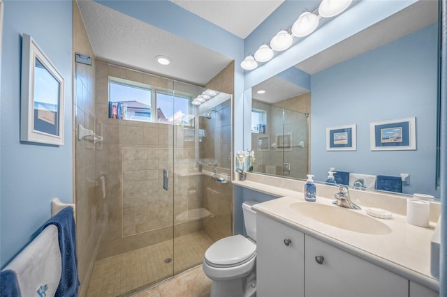 bathroom with vanity, toilet, an enclosed shower, and a textured ceiling