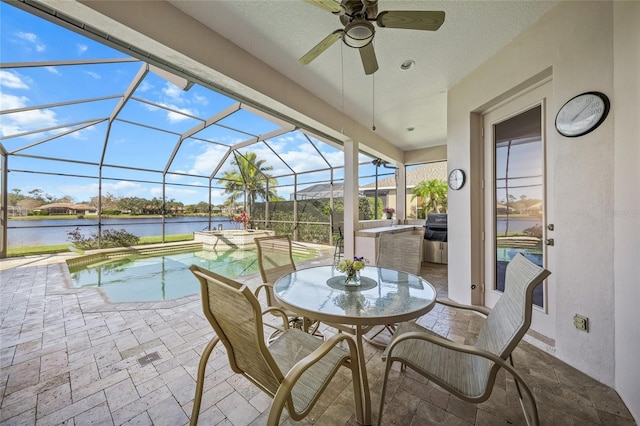 view of swimming pool featuring a patio area, a water view, area for grilling, a lanai, and an in ground hot tub