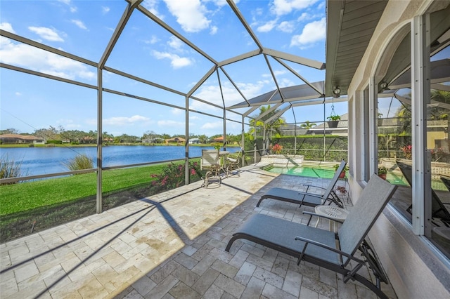 view of patio with a water view, a lanai, and a pool with hot tub