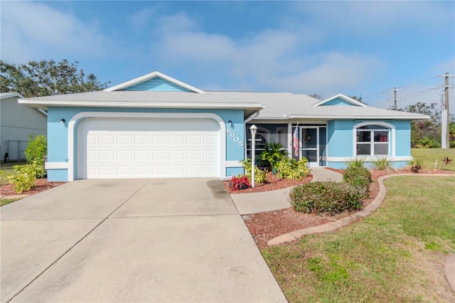 single story home with a garage and a front lawn