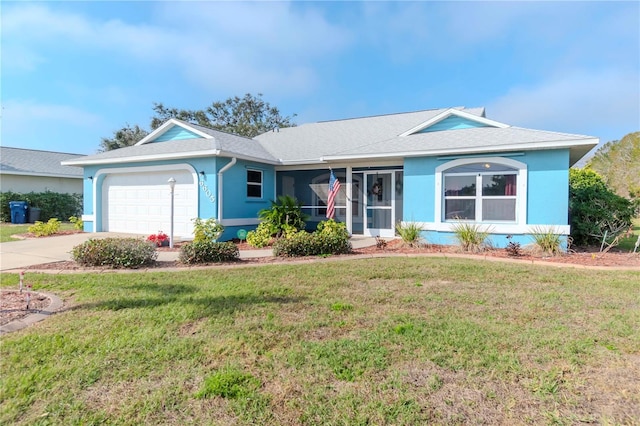 single story home with a garage and a front lawn