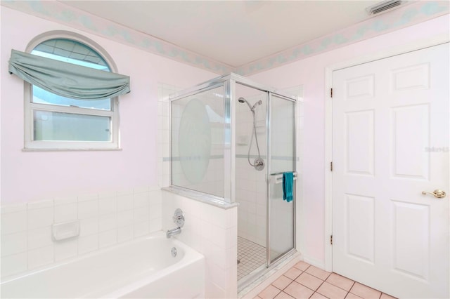 bathroom featuring tile patterned floors and independent shower and bath