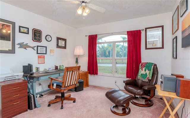 carpeted office space with a textured ceiling and ceiling fan