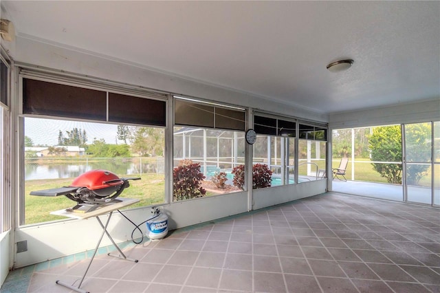 unfurnished sunroom with a water view