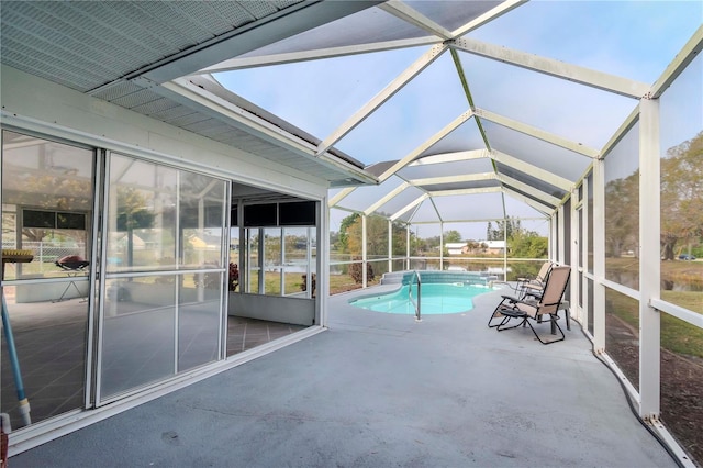 view of pool featuring a patio area and glass enclosure