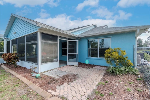 back of house featuring a sunroom