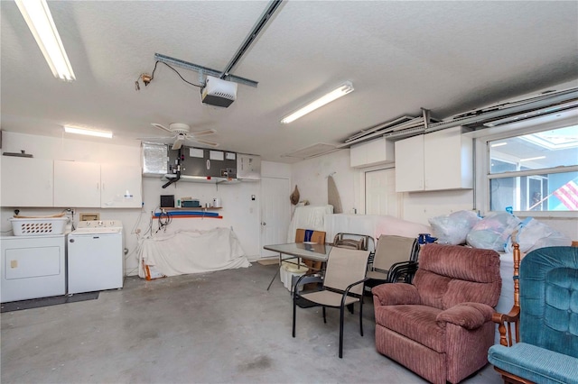 garage with a garage door opener and washing machine and dryer