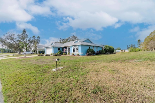 view of front of property with a garage and a front yard