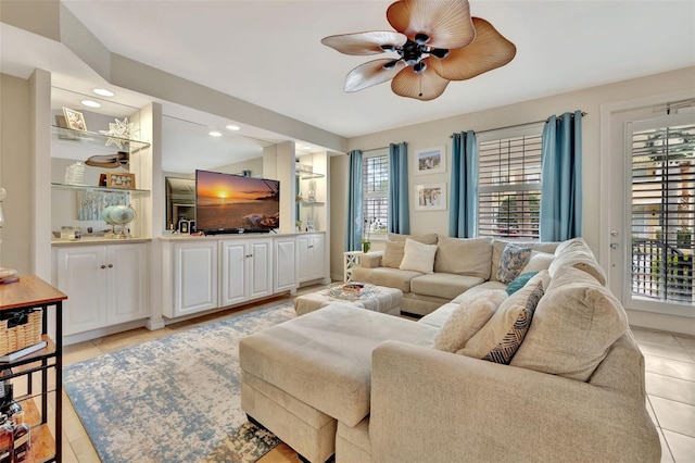 living room featuring light tile patterned floors and ceiling fan