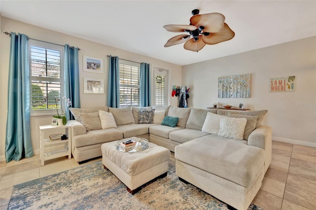 living room featuring light tile patterned floors, a ceiling fan, and baseboards