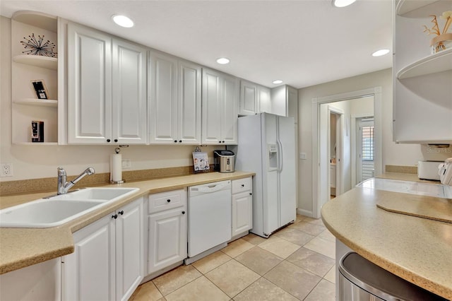 kitchen featuring light tile patterned flooring, white appliances, sink, and white cabinets