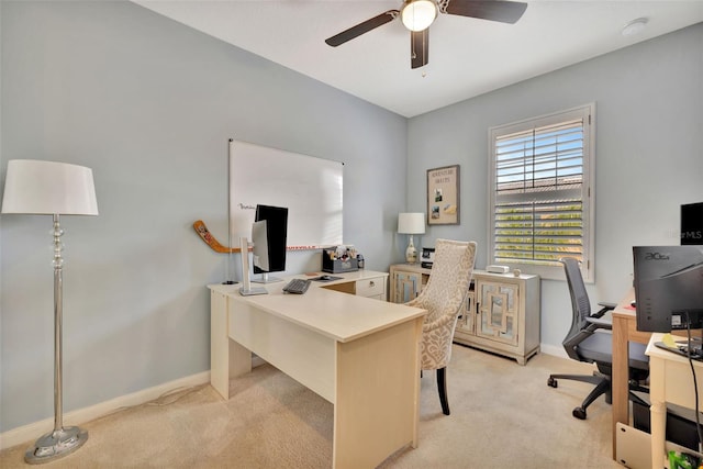 carpeted office featuring ceiling fan