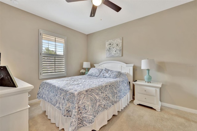 bedroom featuring light carpet and ceiling fan