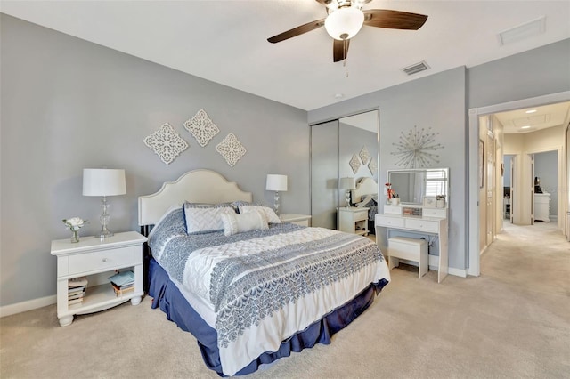 bedroom featuring ceiling fan, light colored carpet, and a closet