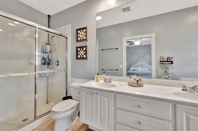 bathroom with ceiling fan, vanity, toilet, and a shower with shower door