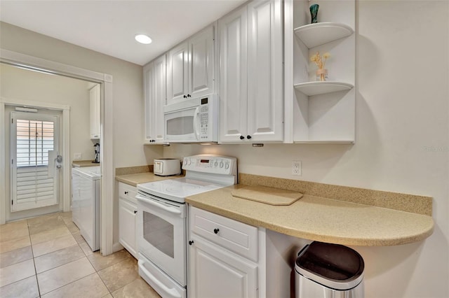 kitchen featuring white appliances, white cabinets, washing machine and clothes dryer, light countertops, and open shelves