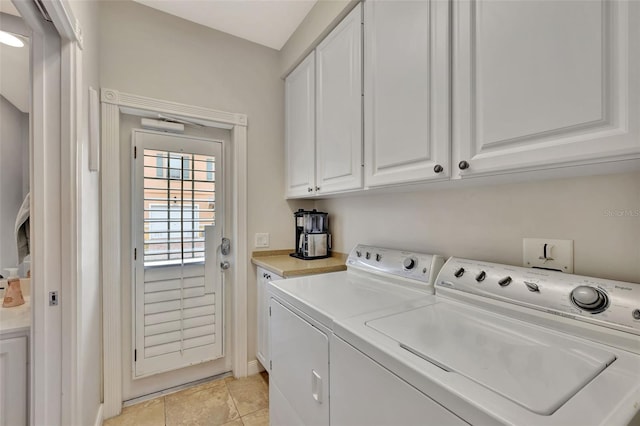 laundry area with cabinet space, light tile patterned flooring, and independent washer and dryer