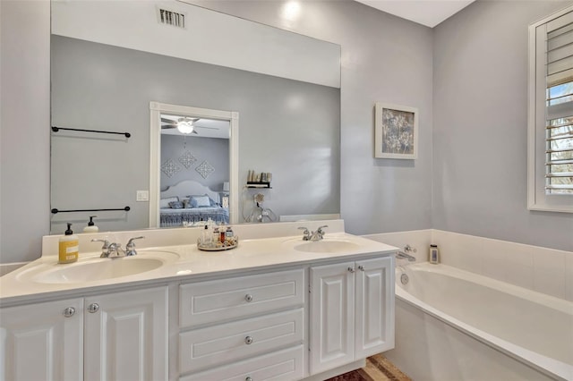 ensuite bathroom with a sink, double vanity, ensuite bath, and visible vents