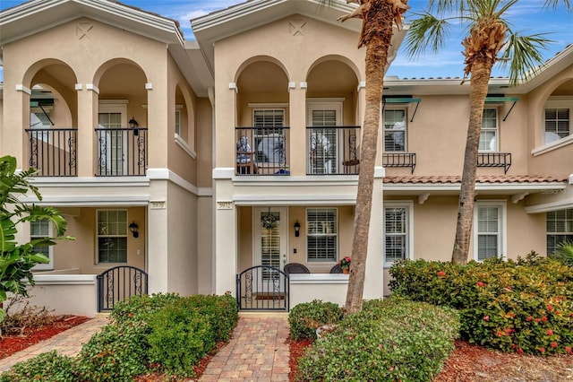 view of front of home with a gate and stucco siding