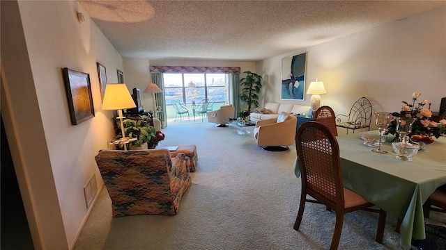 carpeted dining space featuring a textured ceiling