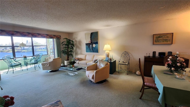 living room featuring a water view, carpet floors, and a textured ceiling