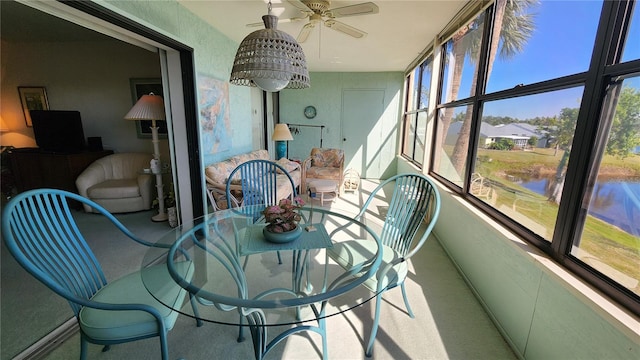 sunroom featuring ceiling fan