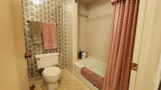 bathroom featuring shower / bath combination with curtain and toilet