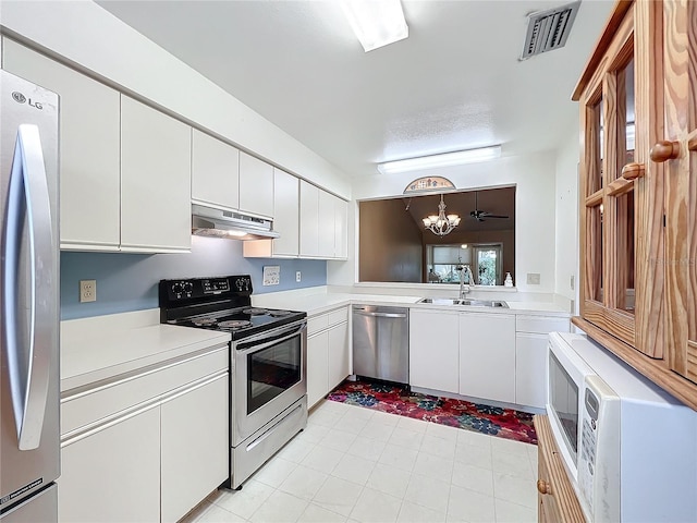 kitchen featuring sink, hanging light fixtures, white cabinets, and appliances with stainless steel finishes