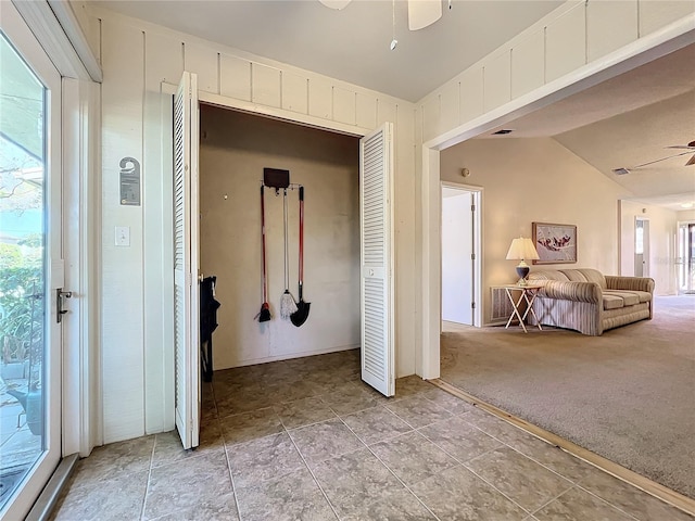 unfurnished bedroom featuring lofted ceiling, ceiling fan, carpet floors, access to outside, and a closet