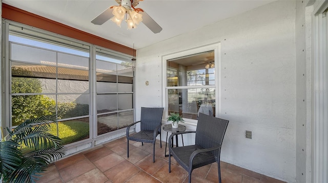 sunroom featuring ceiling fan