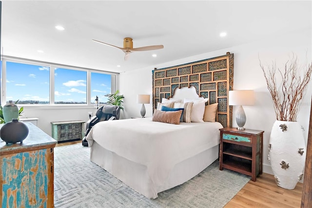 bedroom with light hardwood / wood-style flooring and ceiling fan