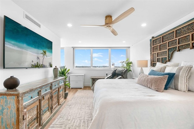 bedroom with light hardwood / wood-style floors and ceiling fan